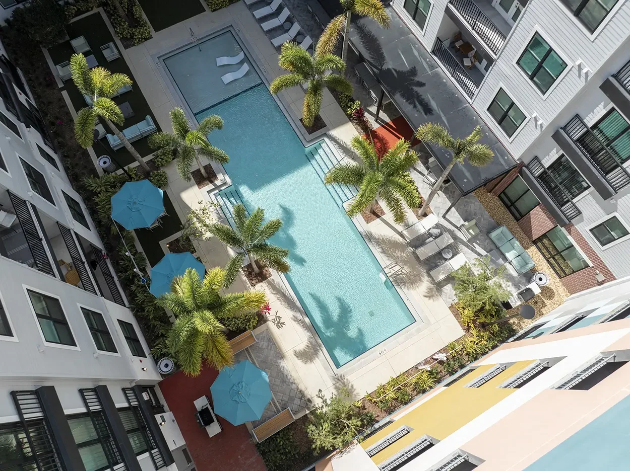 overhead view of highrise apartment community pool amenities