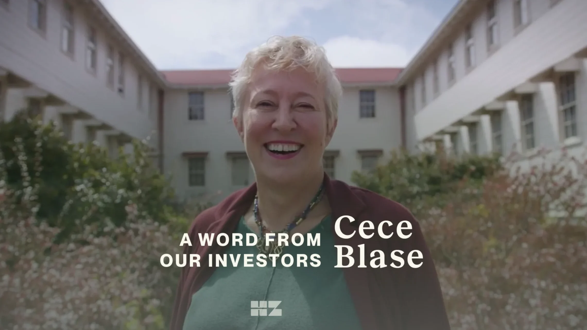 video still of woman smiling in front of real estate with text overlay: a word from our investors